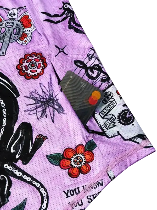 Purple cycling shorts with tattoo-style graphics, skulls, flowers, and music notes for men and women