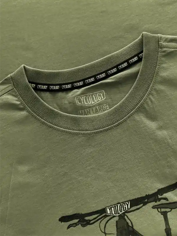 Olive green men's cycling t-shirt with bike graphic and branded tag, ideal for casual or ride wear.