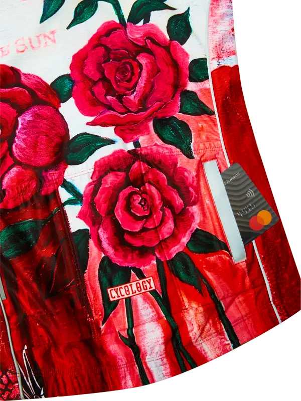 Red cycling jersey with large pink roses and 'Cycology' branding on a white background