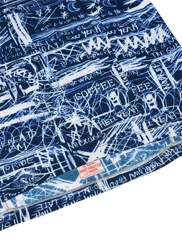 Blue cycling jersey with white graffiti-style graphics and bold text, featuring edgy street art design for riders.