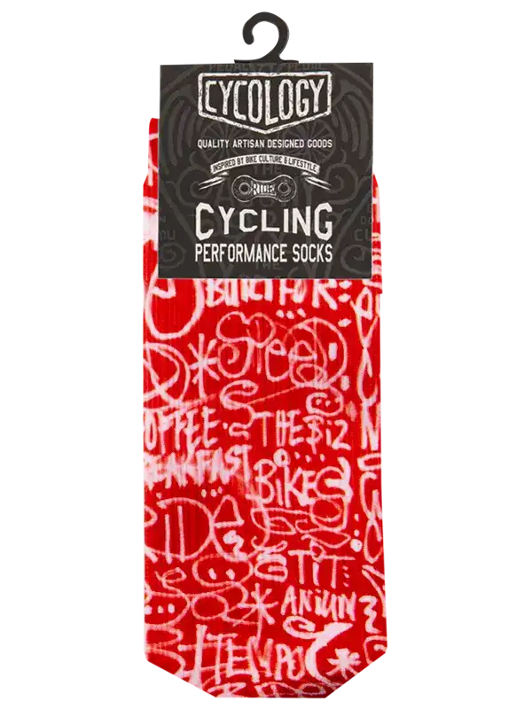 Red and white patterned cycling socks in retail packaging with a black header card. The socks feature a white graffiti-style print with words like 'COFFEE', 'BIKES', and 'THE 12'.