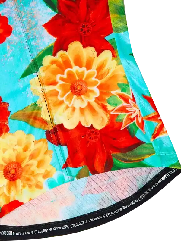 Vibrant floral cycling jersey with red and yellow flowers on turquoise background, breathable mesh hem