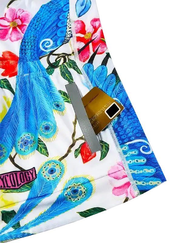 Cycling shorts with vibrant peacock and floral print, featuring secure zip pocket for essentials.