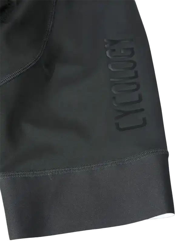 Black cycling shorts with embossed Cycology logo, high-quality fabric, designed for comfort and performance.