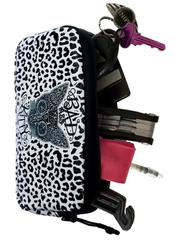 Leopard print cycling key pouch with cat design, holding keys and tools for bike riders