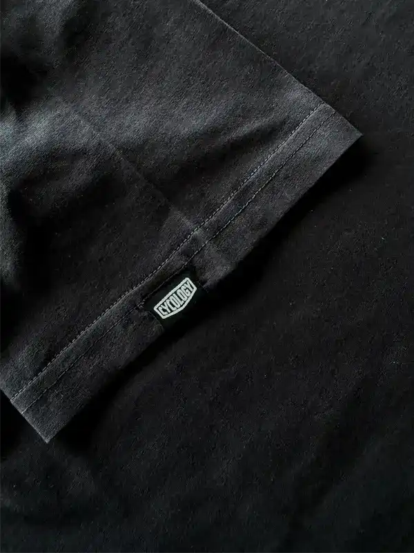 Black cycling t-shirt with branded tag, high-quality fabric detail