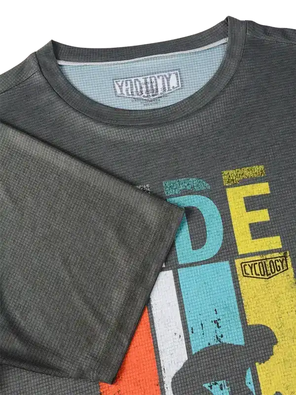Grey men's cycling jersey with colorful graphic design and waffle texture fabric