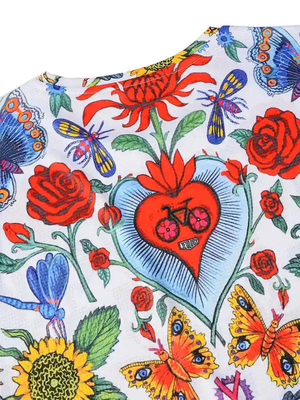 Vibrant floral cycling jersey with butterflies, roses, and heart-shaped bike design on white fabric