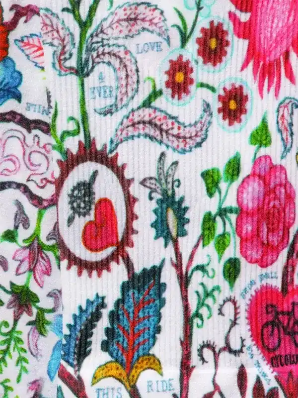 Colorful floral cycling jersey with heart, bike, and 'Love This Ride' print on white fabric