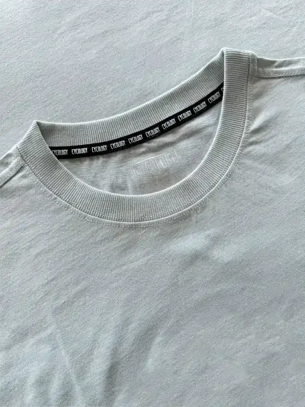 Light gray cycling t-shirt with branded neck tape, soft fabric detail for men's and women's bike wear