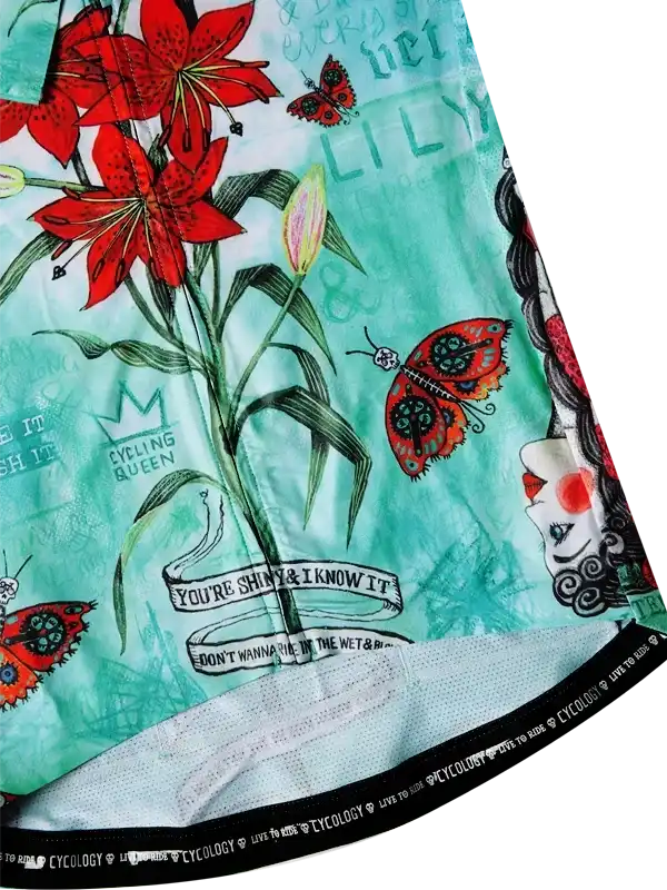 Women's cycling shorts with red lilies, butterflies, and 'Cycling Queen' print on mint green fabric