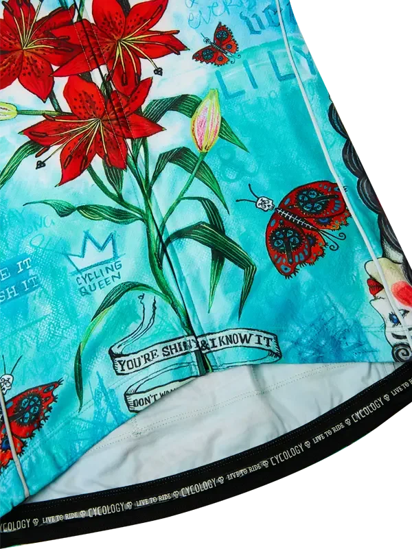 Cycling jersey with red lilies, butterflies, and 'Cycling Queen' design on turquoise fabric