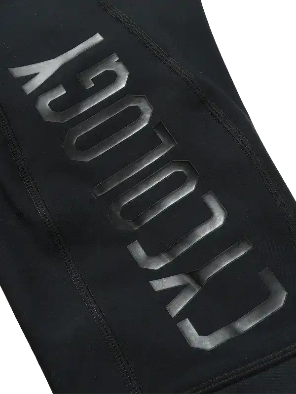 Black cycling apparel with bold reflective 'CYCOLOGY' branding, high-quality fabric detail