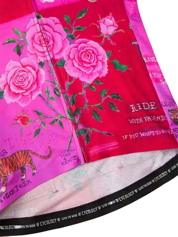 Pink floral cycling jersey with roses, tiger print, and 'Ride With Friends' text on vibrant fabric