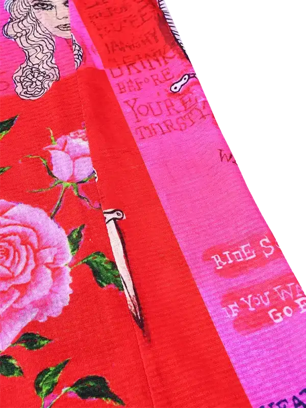 Vibrant red cycling jersey with pink roses, green leaves, and motivational text, designed for women riders.