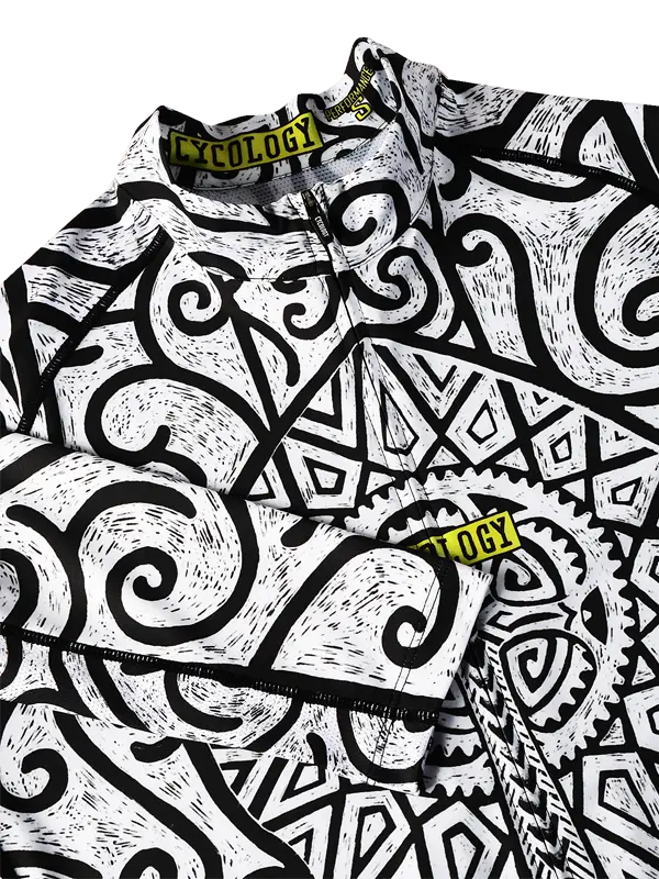 Close-up of Zanzibar Men's White Long Sleeve Summer Cycling Jersey with black and white geometric pattern and 'Cycology' branding.
