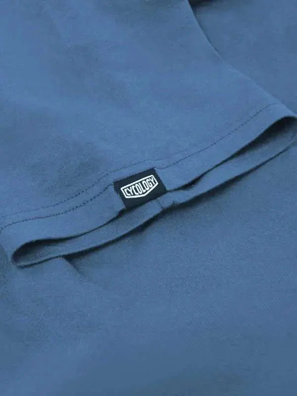Cycology branded tag on blue cycling apparel, showcasing quality fabric and design detail