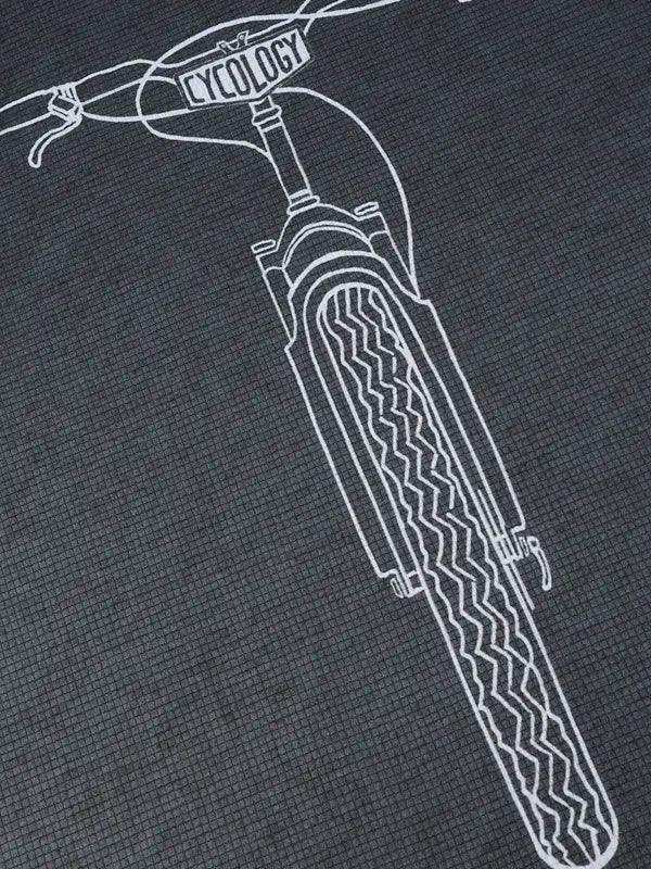 Cycling apparel with white line art of bike front fork and tire on dark fabric, featuring 'CYCOLOGY' on handlebar