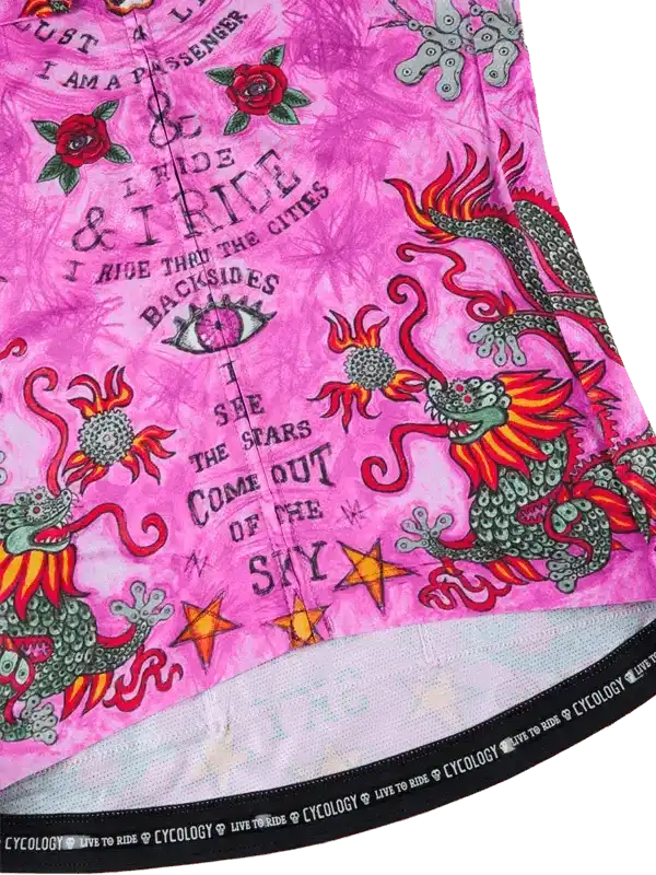 Pink cycling jersey with dragon, roses, and stars design, featuring 'I ride' text and Cycology branding