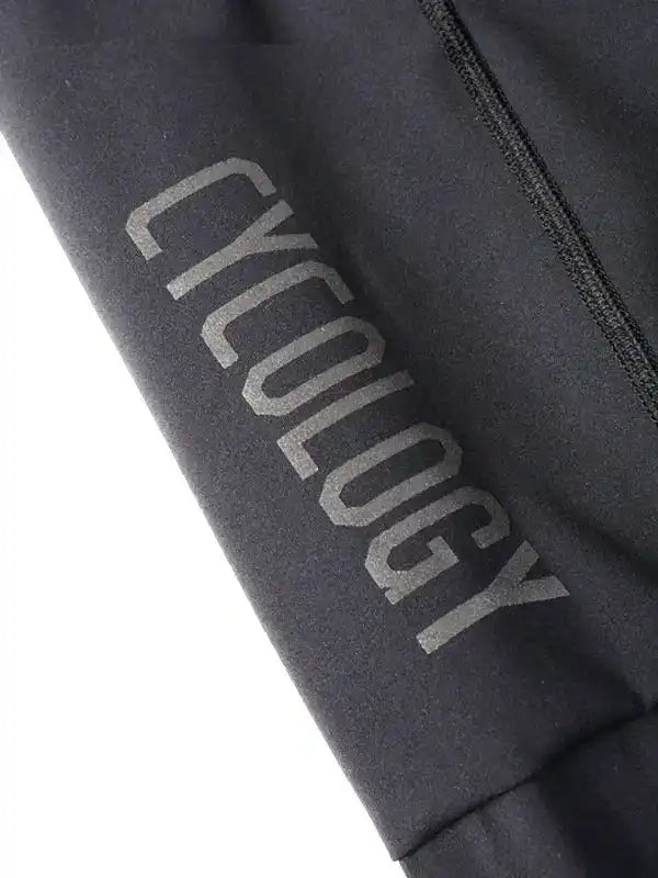 Black cycling apparel with 'CYCOLOGY' logo, high-quality fabric detail for men's and women's rides