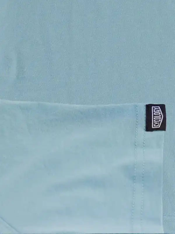 Light blue cycling jersey with black brand tag, soft fabric detail