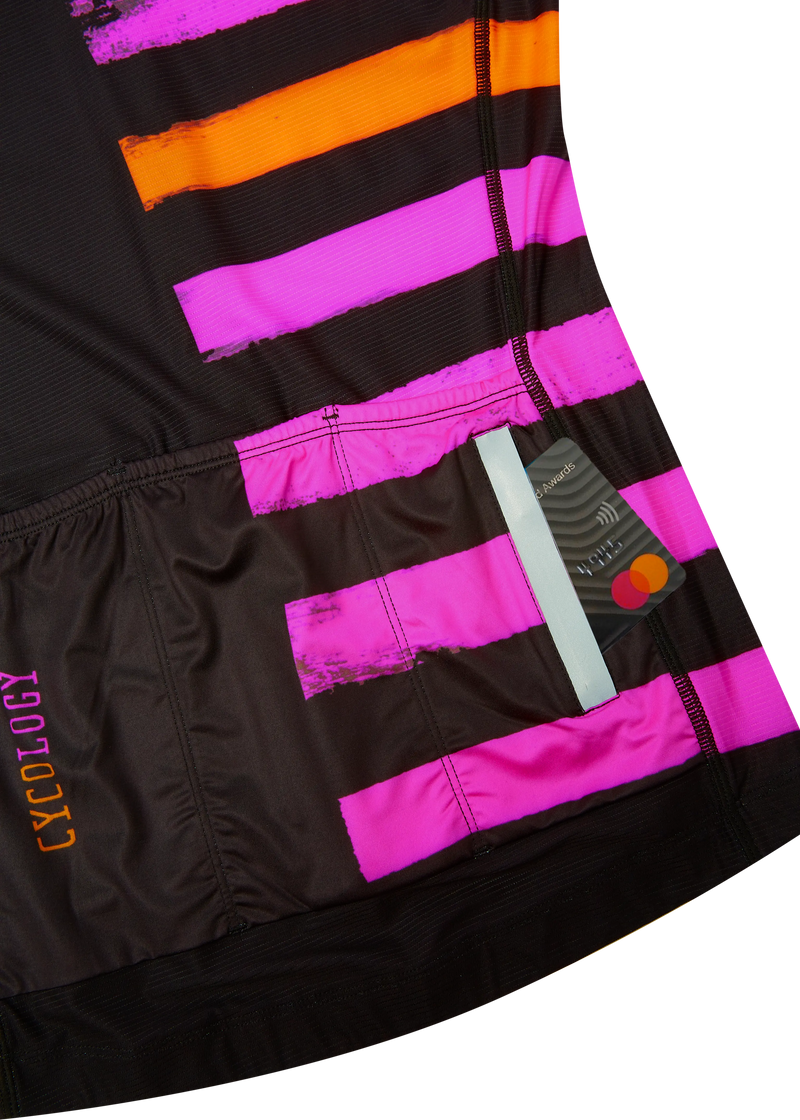 Close-up of a black, pink, and orange striped cycling jersey  with 'Cycology' branding.