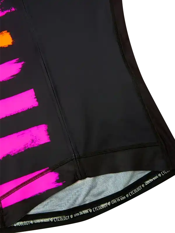 Black cycling shorts with bold pink and orange brushstroke design, featuring 'CYCOLOGY LIVE TO RIDE' waistband.