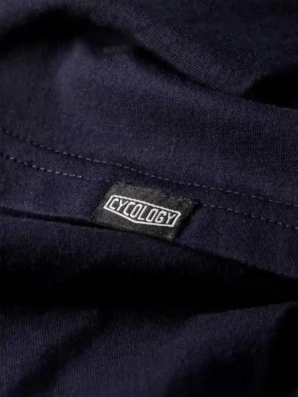 Cycology brand label on dark navy cycling apparel fabric, showcasing quality stitching and design detail.
