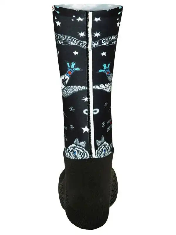 Black cycling leg warmer with star, rose, and tattoo-style graphics, featuring 'Freedom from Chains' text