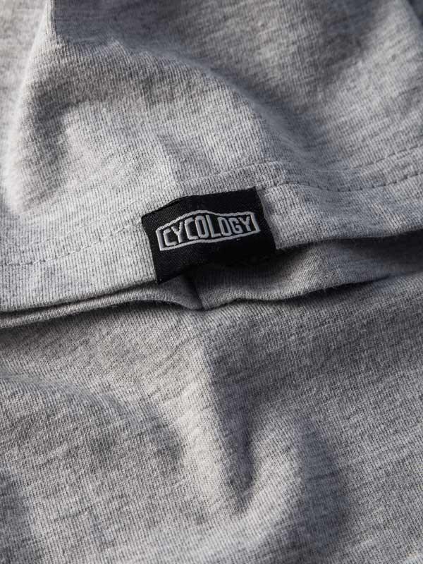 Grey cycling apparel with Cycology brand tag, showcasing high-quality fabric details
