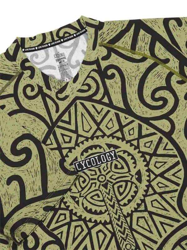 Men's cycling jersey with bold black tribal and gear pattern on olive green, featuring 'CYCOLOGY' logo.
