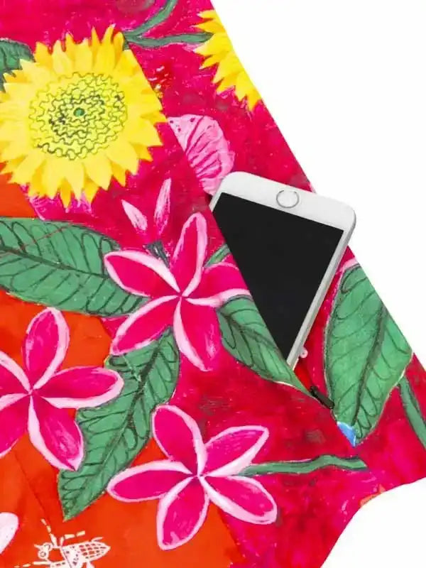 Vibrant floral cycling jersey pocket holding smartphone, sunflower and plumeria print, ideal for rides