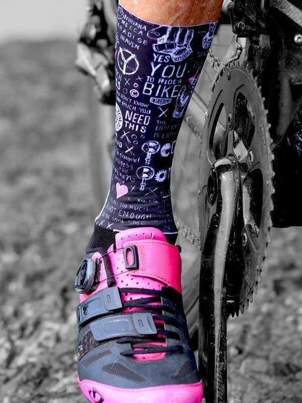 Cycling socks with bike-themed graphics paired with pink cycling shoes, ideal for road or mountain biking.