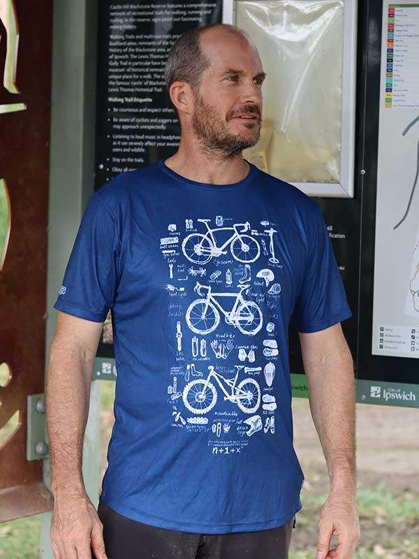 Man wearing blue cycling t-shirt with bike diagram print, ideal for cyclists seeking stylish, functional apparel.