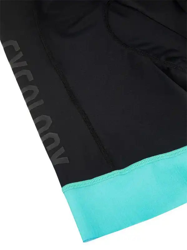 Black cycling shorts with teal hem and subtle branding, designed for comfort and performance.