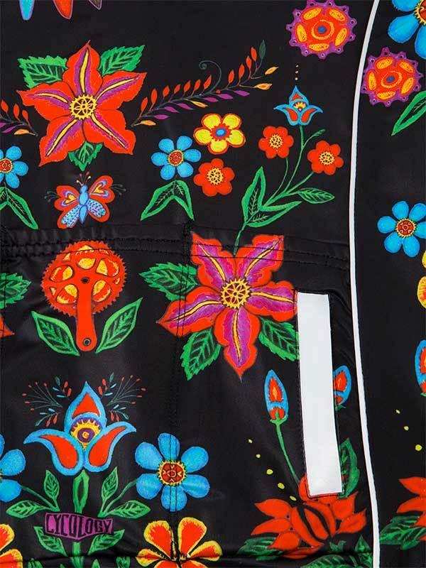 Vibrant floral print cycling jacket with bold red, blue, and orange flowers on black fabric