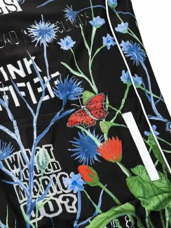 Black cycling jersey with blue flowers, red butterfly, and bold text design