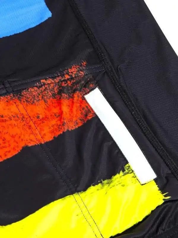 Men's cycling jersey with bold orange, yellow, and blue graphic design on black fabric