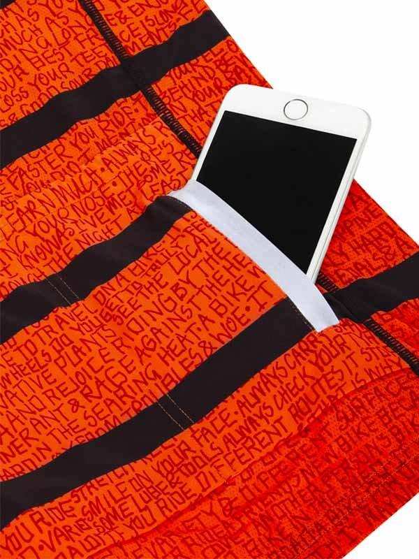 Orange cycling shorts with black stripes and text print, featuring a phone pocket for storage