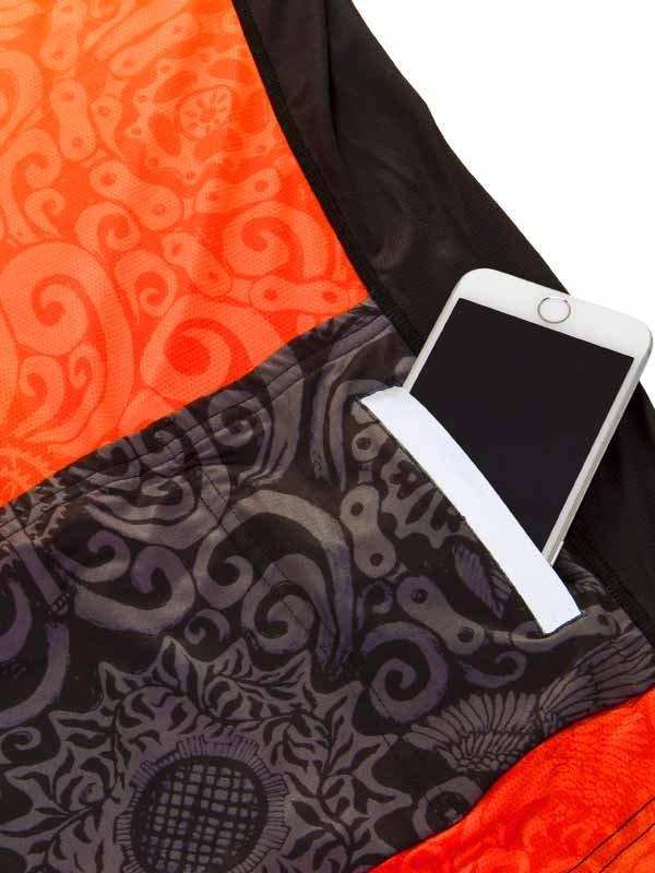 Cycling jersey pocket holding smartphone, orange and black patterned design for bike rides