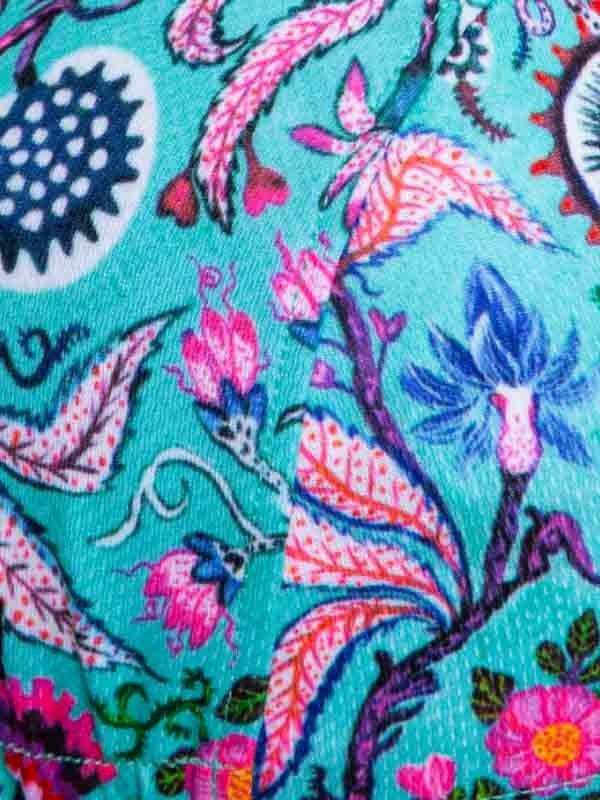 Vibrant floral cycling jersey with pink, blue, and teal botanical print on performance fabric