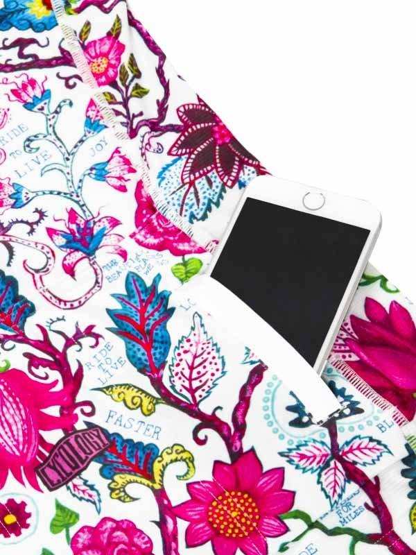 Colorful floral cycling shorts with phone pocket, vibrant print, and motivational phrases for riders