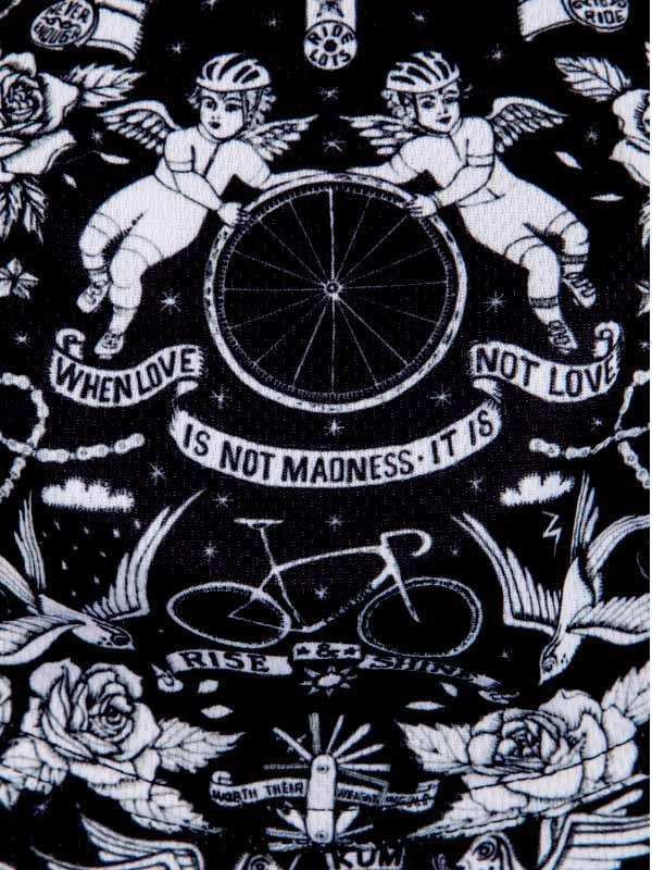 Black and white cycling-themed fabric with angel cyclists, bike wheel, roses, and motivational phrases