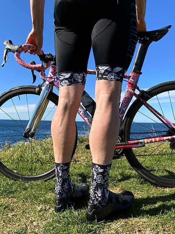 Cycling shorts and patterned socks with bike by ocean, men's cycling apparel
