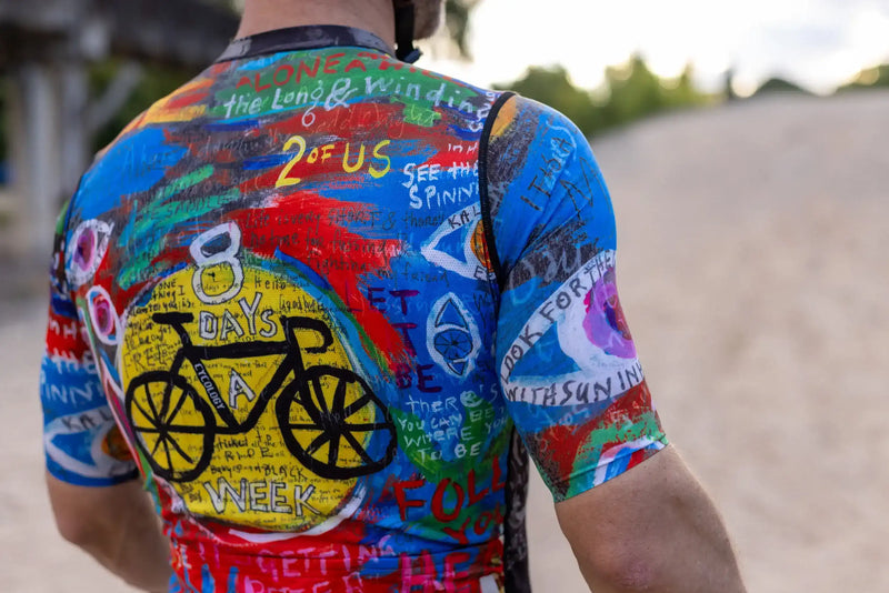 Men's colorful cycling jersey with bold graphics and text, featuring '8 Days a Week' and bike design, ideal for road rides.