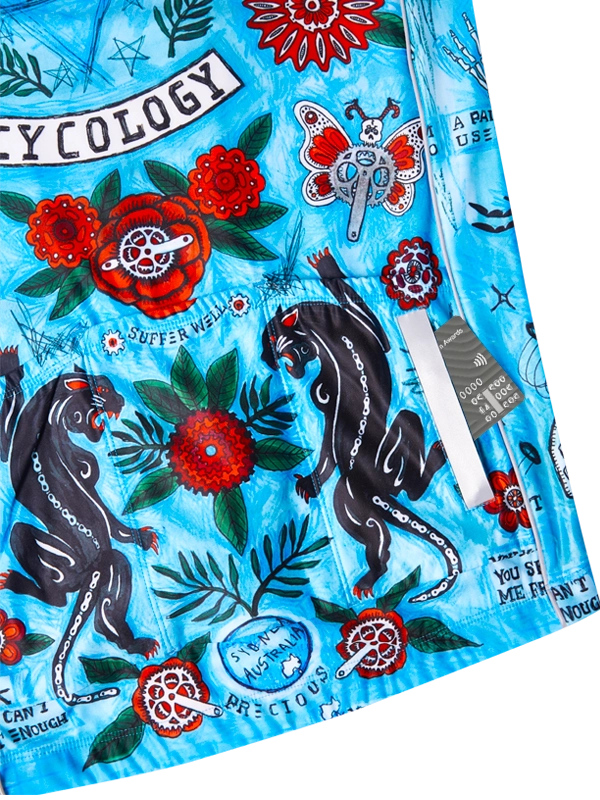 Colorful cycling jersey close up with panther designs, flowers, and text on a blue background