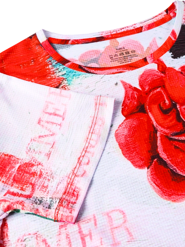 Technical  women's T-shirt with red and pink rose design on a white background- neck close up
