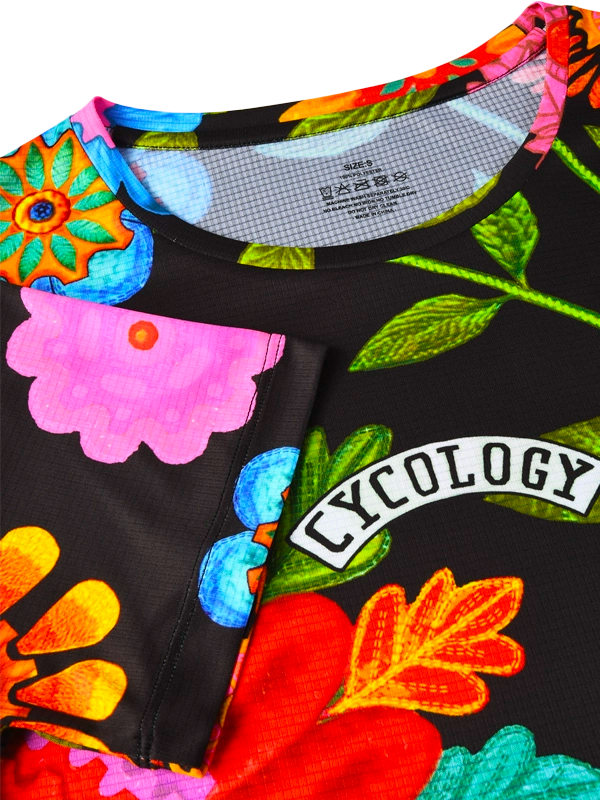 Women's Colorful  tech t-shirt with floral and insect design on a black background