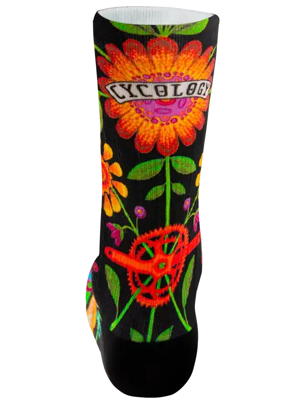A single crew cycling sock with a black background and a vibrant, colorful floral and gear pattern. The word 'CYCOLOGY' is printed across the upper portion in a retro font.