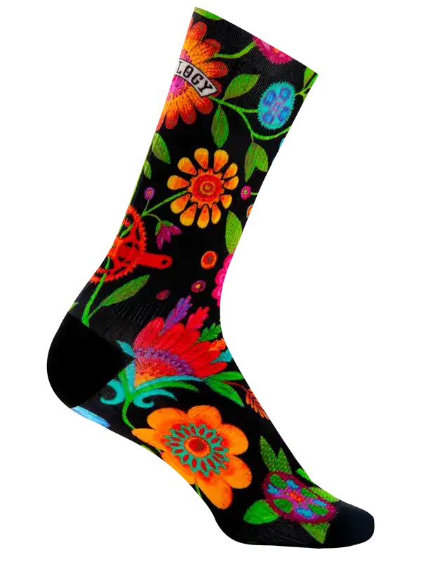 A single crew cycling sock with a black background and a vibrant, colorful floral and gear pattern. The word 'CYCOLOGY' is printed across the upper portion in a retro font.